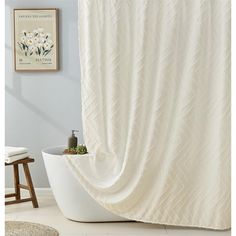 a white bath tub sitting next to a shower curtain