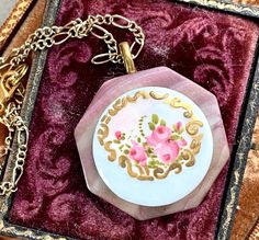 This lovely hand painted antique porcelain stud button has been set upon a vintage mother of pearl buckle to create this simply lovely pendant necklace.  These were produced in the 1800's  and early 1900's, painted by hand, some as cottage industries.   I work with antique and vintage parts. Some may show signs of wear or age. Please look at each picture closely. I have tried to show all aspects of my work. Please contact me before purchasing if you have any questions or would like more clarity Vintage Enamel Round Pendant Necklace, Vintage Enamel Necklace With Round Pendant, Vintage Enamel Necklace With Large Pendant, Vintage Round Pendant Jewelry For Mother's Day, Vintage Round Pendant Necklace For Mother's Day, Vintage Enamel Flower Pendant Jewelry, Antique Enamel Necklace For Wedding, Vintage Hand Painted Round Pendant Necklace, Antique Enamel Necklaces For Wedding