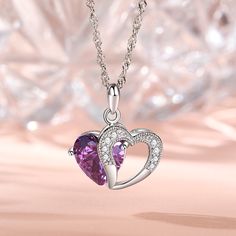 A sparkling tribute to you, this heart necklace is a special look you are certain to adore. Crafted in sterling silver, it features a shimmering purple heart-shaped stone with an open heart-shaped frame. Smaller stones adorns heart frame, adding subtle sparkle. It's a sweet and romantic gift for you or your loved ones.Carat Weight: 5.97 ctStone Size: 10*10 mmStone Type: Jeulia® StoneNumber of Stones: 1 Stone Color: Amethyst PurpleStone Shape: HeartCarat Weight: 0.374 ctStone Size: 1.3,1.5 mmSton Purple Double Heart Jewelry For Gifts, Purple Double Heart Jewelry Gift, Purple Sterling Silver Heart Cut Necklace, Purple Cubic Zirconia Jewelry For Valentine's Day, Purple Double Heart Jewelry With Heart Charm, Purple Heart Cut Sterling Silver Necklace, Purple Heart-cut Sterling Silver Necklace, Purple Double Heart Charm Jewelry, Heart Cut Purple Jewelry For Valentine's Day