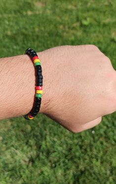 A lively tribute to Rastafarian heritage and style. This bracelet showcases a harmonious blend of red, green, yellow, and black beads, meticulously crafted to embody the spirit of unity and freedom. Each bead is carefully selected and strung on a durable elastic band, ensuring a comfortable fit for any wrist size. Ideal for casual wear, festivals, or as a bold statement piece, this Rasta Bead Bracelet infuses your look with vibrant energy and a touch of bohemian flair. Black Wristband With Colorful Beads Gift, Casual Black Round Beads Friendship Bracelets, Casual Black Friendship Bracelets With Round Beads, Casual Black Round Beads Friendship Bracelet, Casual Black Friendship Bracelet With Black Beads, Casual Multicolor Jewelry With Black Beads, Adjustable Black Friendship Bracelet With Colorful Beads, Adjustable Black Wristband With Colorful Beads, Black Friendship Bracelets With Colorful Beads As Gift