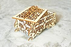 an intricate wooden box sitting on top of a table