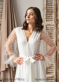 Chic Wedding Dress With Sheer Sleeves, Elegant Dresses With Lace Sleeves For Wedding Night, Elegant Wedding Night Dress With Lace Sleeves, Flowy Dress With Sheer Sleeves For Wedding, White Gown With Sheer Sleeves, V-neck Wedding Night Dress With Lace Sleeves, Feminine Wedding Robe With Kimono Sleeves, Elegant White Robe With Lace Sleeves, Fitted Lace Sleeves Wedding Robe