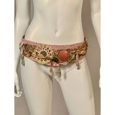 An amazing belt in the rich hippie style of the 1970's is made from pink faux alligator or stamped leather and pink suede with a pink snakeskin disk and a shell and straw ornament. In addition there are strands of glass beads, beads dangling from pink suede strips and metallic braid trim , all on a base of painted suede. The side of the belt are made from soft pink suede and they tie at the center back. The belt still retains the original store tag and it is also stamped in gold on the inside. I Straw Decorations, Alligator Belt, Stamped Leather, Suede Belt, Pink Suede, Beaded Dangles, Hippie Style, Pink Leather, Snake Skin