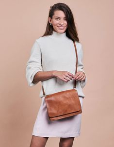 Our Audrey is a sleek and minimalist design that works well no matter the season or your outfit! The smooth leather satchel has an external front compartment and a canvas-lined interior that features a roomy compartment with a zipped side pocket for your belongings. Two open inside pockets make it easy to stow away smaller items. And we haven't got to the best bit yet - this bag comes with two straps! Feeling like switching up your look, while keeping it classy? Use the checkered strap and every Timeless Everyday Satchel Flap Bag, Everyday Timeless Satchel Flap Bag, Modern Cognac Saddle Bag With Detachable Strap, Timeless Shoulder Bag For Travel In Fall, Timeless Brown Flap Bag For Everyday Use, Modern Brown Satchel With Detachable Strap, Timeless Cognac Shoulder Bag For Everyday, Versatile Cognac Shoulder Bag For Business, Classic Everyday Satchel Flap Bag