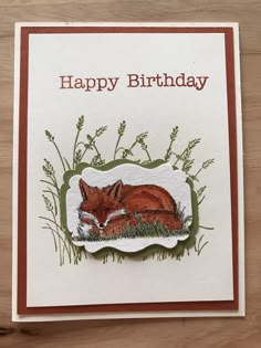 a happy birthday card with an image of a fox laying in the grass on top of it