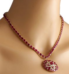 Stamped: 14K Yellow Gold Total Necklace Weight: 29.0 Grams Necklace Length: 17 Inches Necklace Width: N/A Gemstone Weight: Total Natural Center Ruby Weight is 1.85 Carat (Measures: 8.85x7.05 mm) Color: Red Gemstone Weight: Total Natural Side Ruby Weight is 52.00 Carat Color: Red Diamond Weight: Total Natural Diamond Weight is 1.50 Carat Quantity: 54 Color: F-G, Clarity: VS2-SI1 Face Measures: 33.50x33.70 mm Sku: [702598W] Oval Diamond Necklace With Jewels, Diamond Necklace With Jewels, Dazzling Round Diamond Necklace With Jewels, Dazzling Round Diamond Necklace, Formal Round Diamond Necklace With Gemstones, Anniversary Diamond Necklace With Jewels, Luxury Ruby Necklaces With Diamond Accents, Dazzling Ruby Necklace With Diamond Cut, Luxury Ruby Necklace With Diamond Accents