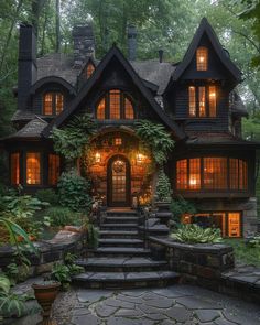 a large house with lots of windows and steps leading up to the front door, surrounded by greenery