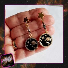 Space dangle earrings. A mix of silver and gold. A beautiful black and silver space charm (with gold backing), with silver star, and star stud. * Inspired by the cosmos: These space dangle earrings feature a mix of silver and gold, with a stunning black and silver space charm (gold backing). * Design details: Charm, Silver star, and gold star stud, making a captivating statement piece. * Materials: Crafted with high-quality materials to reflect the beauty of the universe. Perfect for space lover Earrings Space, Space Earrings, Star Stud Earrings, Stud Earrings Silver, Space Lovers, Star Earrings Stud, Star Studs, Black And Silver, Silver Stars