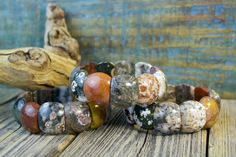 Each bead in this gorgeous Ocean Jasper bracelet is a mini-masterpiece! The colors are a unique mix of earthy tones and the patterns on each stone bead are unique. Each bracelet is truly one-of-a-kind! (7.5" x .75" wide) Ocean Jasper is a protective, multi-colored stone with spherical patters that are said to hold ancient mystic knowledge and wisdom. It has a gentle and nurturing energy. This stone can help reveal and facilitate the healing of unresolved emotions, inspiring peace and happiness. Handmade Jasper Artisan Bracelet, Handmade Artisan Jasper Bracelets, Handmade Earthy Multicolor Beaded Bracelets, Handmade Multicolor Earthy Beaded Bracelets, Earthy Handmade Multicolor Beaded Bracelets, Earthy Jasper Gemstone Bead Bracelets, Earthy Jasper Gemstone Beads Bracelet, Handmade Multicolor Nature-inspired Beaded Bracelets, Earthy Jasper Round Bead Bracelets