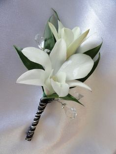 a bouquet of white flowers sitting on top of a bed