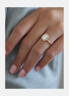 a woman's hand with a diamond ring on it