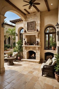 an outdoor living room with fireplace and seating area