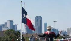 a man in a cowboy hat is holding a texas flag and waving his arms out