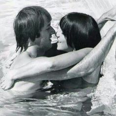 a man and woman in the water holding each other