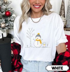 Celebrate the festive season in style with our Merry Christmas Snowman Comfort Colors T-shirt! This adorable holiday shirt features a cheerful snowman, making it the perfect addition to your family Christmas wardrobe.   Product Info  Comfort Colors® 1717 is garment dyed and made with 100% ring-spun cotton. Fabric is Pre-Shrunk Relaxed Fit  Care Instructions  Turn Garment Inside Out Machine Wash on COLD DO NOT IRON PRINT Do Not Dryclean Dry on Low Settings   Sizing  ✺ Sizing is unisex  ✺ For adults, size runs like men's, though not overly large. Most women find their typical size works best, since they are meant to fit a touch loose and go up 1 or 2 sizes if you want the oversized look. ✺ Size guide and fit:  The size chart is listed in photos above.  Please use the measurement for the most White Christmas T-shirt Gift, White Graphic Tee For Holidays, Winter Gift Cotton T-shirt, White Festive Shirt For Christmas, White Festive Christmas Shirt, Festive Winter Short Sleeve Shirt, Cotton T-shirt For Winter Gift, Festive Short Sleeve Winter Shirt, White Short Sleeve Christmas Shirt