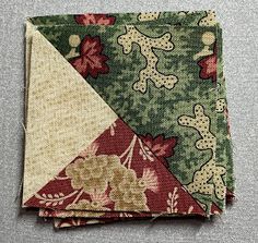 two pieces of fabric with flowers and leaves on them, one is folded in half