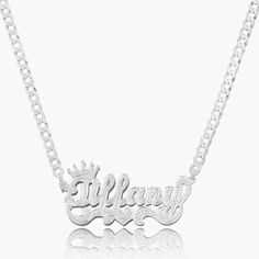 Our popular Double Plated Iced Princess Crown Name Necklace boasts a chic and elegant design, handcrafted to perfection. The model showcases the necklace with an 18-inch Cuban chain (see video for reference). You can personalize this item with Letters, Numbers, and Roman Numerals and choose from chain lengths of 14", 16", 18", and 20". Each chain features a lobster clasp closure for secure wear.Chain width:Cuban Chain - 3.7 mmFigaro Chain - 3 mmRope Chain - 2.3 mm XO Chain - 5 mm White Gold Pendant Necklace With Curb Chain, Elegant Silver Charm Necklace With Curb Chain, Elegant Charm Necklace With Curb Chain As Gift, Luxury Sterling Silver Personalized Necklace, Elegant Curb Chain Charm Necklace Gift, Elegant Curb Chain Charm Necklace For Gift, Pendant Necklace With Curb Chain As Gift, Elegant Nameplate Curb Chain Necklace, Silver 14k Gold Charm Necklace With Adjustable Chain