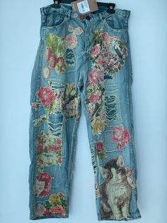 a pair of jeans with flowers on them