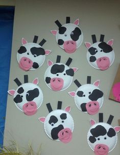 paper plates with farm animals on them are arranged in the shape of cow's heads