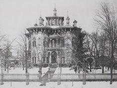 an old photo of a large building in the snow