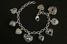 A collection of silver filigree-style heart charms have been dispersed around a shimmering silver plated bracelet chain in this handmade charm bracelet. This heart charm bracelet is then completed with a lobster clasp and a 1/2 inch of chain at the end for adjustable sizing. Charms in this bracelet include nine assorted heart charms in various decorative filigree designs. ● Sizing ● To determine your bracelet size, do a snug measurement of your wrist's circumference, then add 1/2 an inch. 6 to 6 Bracelet Fancy, Handmade Charm Bracelets, Hearts Bracelet, Filigree Heart, Bracelet Heart, Silver Plated Bracelet, Filigree Design, Handmade Charms, Bracelet Handmade