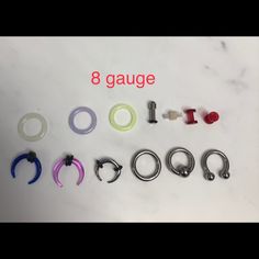 eight gauges are arranged in different colors and sizes on a white surface with the words 8 gauge below them