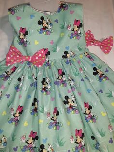 Minnie Mouse Easter Dress Very Limited Fabric - can not re order - enough fabric to make only 1 dress - Adorable Easter Minnie Mouse Spring Summer Dress All little girls will love being the center of attention in this beautiful handmade dress Great for Easter -Photo Shoot - Birthday Party-Play Date or any Special Occasion Little Girls Baby Toddler Dress This will be made and ready within 3 days of order **SIZES Available -6 mo. to 2yr. Very Limited supply on this Fabric-- Bodice is fully lined i Fitted Sleeveless Dress For First Birthday, Playful Sleeveless Dress With Bow, Playful Fitted Minnie Mouse Dress, Playful Minnie Mouse Fitted Dress, Playful Minnie Mouse Summer Dress, Cute Green Dress For First Birthday, Playful Minnie Mouse Dress-up Dress, Playful Minnie Mouse Dress For Dress-up, Playful Sleeveless Easter Dress