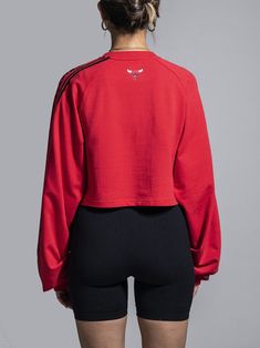 Looking for a stylish and comfortable way to show off your team spirit? Look no further than the Qoreware Team Crop Top. Our crop top is made from high-quality materials, ensuring that you stay comfortable while supporting your team. The top features a sleek and modern design, making it perfect for pairing with yoga pants, high-waisted jeans or skirts. Show off your body curves and create a perfectly proportioned effect. - Unique fabric blend including modal made from birch trees - 58% Cotton, 3 Sporty Crew Neck Crop Top For Streetwear, Collegiate Tops With Three Stripes For Streetwear, Sportswear Crop Top With Crew Neck For Gym, Functional Sports Crop Top With Crew Neck, Sporty Moisture-wicking Crew Neck Crop Top, Functional Crew Neck Crop Top For Sports, Moisture-wicking Sporty Crew Neck Crop Top, Sporty Crew Neck Crop Top, Red Sporty Crop Top For Streetwear