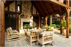 an outdoor living area with chairs, table and fire place