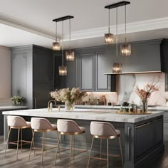 a kitchen with gray cabinets and marble counter tops, gold accents on the bar stools