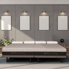 an image of a bed in the middle of a room with three mirrors on the wall