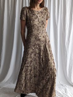 Catch everyone's eye in this stunning sequined floral lace maxi dress!  - Elegant handmade rose embroidery adds shimmering accents  - Flattering crew neck and plunge back highlight your silhouette - Short sleeves and ankle-grazing length keep you comfortable - Inner lining and back zip closure ensure a perfect, secure fit This exquisite lace fabric dress makes a jaw-dropping statement for any special occasion. The intricate floral sequin details give a touch of luxury while the classic maxi silh Fitted Lace Maxi Dress With Short Sleeves, Fitted Floral Embroidery Floor-length Mother Of The Bride Dress, Embroidered Lace Dress For Evening, Spring Fitted Maxi Dress For Mother Of The Bride, Fitted Floor-length Floral Embroidered Mother Of The Bride Dress, Festive Fitted Maxi Dress With Short Sleeves, Fitted Maxi Dress With Short Sleeves For Festive Occasions, Festive Fitted Short Sleeve Maxi Dress, Lace Mother Of The Bride Dress With Sequins