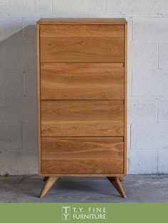 a wooden chest of drawers sitting in front of a white brick wall with the words try fine furniture on it