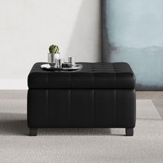 a black ottoman sitting on top of a rug