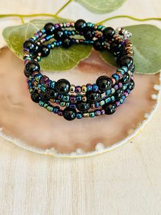 The adorable black and multi color bead memory wire bracelet. Made in the USA. This bracelet is the perfect accessory for any womens wardrobe.  This bracelet is a great womens gift.  Memory wire bracelet will fit any wrist and never loose its shape. Bohemian Black Stretch Bracelet As A Gift, Black Spiritual Bracelets For Party, Bohemian Black Stretch Bracelet As Gift, Multicolor Black Beads Bracelets For Jewelry Making, Adjustable Black Beaded Bracelets With Colorful Beads, Black Beaded Bracelets With Spacer Beads, Black Stretch Bracelet With Spacer Beads As Gift, Black Bracelets With Spacer Beads, Black Bohemian Beaded Bracelets With Spacer Beads