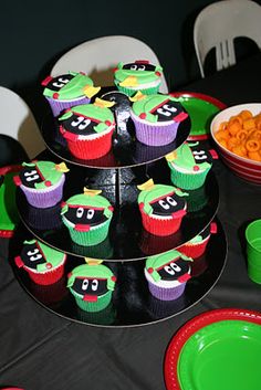 there are cupcakes that have been placed in the shape of ninja turtles on top of each other