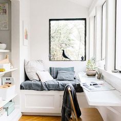 a window seat in the corner of a room with bookshelves on either side