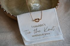 a necklace that says i couldn't tie the knot without you is on it