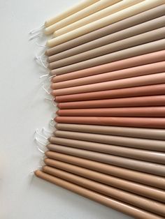 several different colored pencils lined up on a table