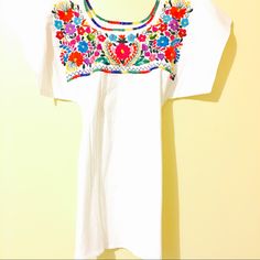 Mexican Embroidered Blouse Hand Embroidered In Colorful Fiesta, Dress It Up Or Tuck In Bell Bottoms Jeans And Vintage Platforms! Aida Coronado Collection Hippie Boho Chic Folk Indigenous Top Ethnic Embroidery Fiesta Festival Vintage Style Nwt High Quality Handcrafted Clothing Fine Details Blouse Top Mexican Vintage Traditional Handmade Ooak Unique Art Folk From Mexico With Love 100% Cotton Medium Weight Colorful Embroidery Party Birthday Mexican Fiesta Blouses White Crew Neck Blouse With Floral Embroidery, White Embroidered Top With Embroidered Hem For Festival, White Folk Style Embroidered Top With Resham Embroidery, White Folk Style Top With Resham Embroidery, Festive White Embroidered Blouse, White Embroidered Top With Hem Detail For Festivals, White Embroidered Blouse For Festive Occasions, Traditional White Embroidered Summer Fabric, Festive Short Sleeve Top With Embroidered Neckline