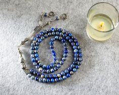 "Product Details * Product Name : REAL Lapis Lazuli 99 Beads Islamic Prayer Beads, Tasbeeh, Misbaha * Material : Natural Lapis Lazuli Stone * Bead Size : 6 mm (Approximately 0,24 Inches) * Bead : 99 pcs * Total Length : 440 mm (Approximately 17,32 Inches) * Length without tassel : 360 mm (Approximately 14,17 Inches) * Colour : As the pictures show * Condition : 100% Brand New Note : The pictures show the real items without any special processing. But the color and brightness may differ a little Polished Round Beads Rosary As Gift, Round Polished Bead Rosary As Gift, Silver Mala With 108 Beads As Gift, Spiritual Silver Beads Mala Gift, Gemstone Beads Rosary As Gift, Silver Beads Rosary As Gift, Spiritual Silver Beads Rosary Gift, Silver Beaded Rosary As Gift, Gift Rosary With Silver Round Beads