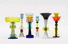 several different colored glass vases sitting next to each other