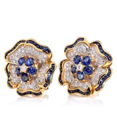 Introducing a pair of exquisite 1960s vintage earrings adorned with a captivating flower motif. Crafted from solid 18K yellow gold, these earrings feature a halo of oval sapphires encircling a dazzling diamond center. The leaves of the flower are beautifully adorned with diamond pave, enhancing their vibrancy and adding a touch of sparkle. The borders of the earrings are adorned with channel-set sapphires, completing the enchanting design. These earrings are designed with sturdy clip-on backs fo Round Diamond Earrings, Jewelry Appraisal, Classic Earrings, Flower Motif, Wedding Jewelry Earrings, Gold Flower, Gems Jewelry, Gold Flowers, Vintage Diamond