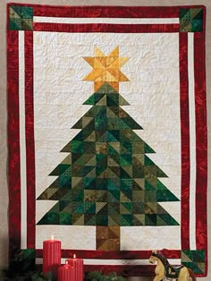 a quilted christmas tree with candles on the mantle