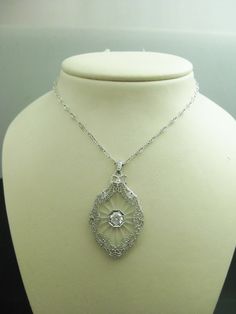 "For Sale: (1) b747 Stunning 14kt White Gold Camphor Glass CZ Pendant and Chain PLEASE READ ENTIRE DESCRIPTION BEFORE PURCHASING This is such a beautiful piece. Made from 14kt white gold and camphor glass with a 1.00ct Cubic Zirconia stone in the center. Stunning filigree work around the edges of the glass. All on a 16\" uniquely designed 14kt white gold chain. Perfect for an Anniversary, birthday, Christmas, or Valentine's Day or whenever gift. Please see pictures for more details! Specifics: 1 Exquisite Hallmarked Diamond Necklace For Formal Occasions, Luxury Filigree Diamond Necklace For Formal Occasions, Art Deco Diamond Necklace In White Gold, Art Deco Platinum Necklace With Diamond Cut, Formal Oval Pendant Diamond Necklace With Single Cut Diamonds, Classic Hallmarked Diamond White Diamond Necklace, Luxury White Gold Diamond Necklace With Filigree, Formal Diamond Necklace With Oval Pendant, Diamond Filigree Necklace In Fine Jewelry Style