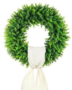 a white scarf tied around a green wreath