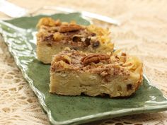 two pieces of dessert sitting on top of a green plate