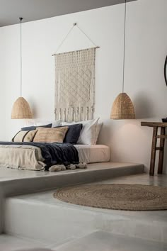 a bed sitting on top of a white floor next to two lamps