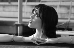 a black and white photo of a woman with her arms crossed