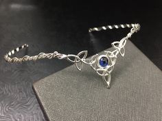 I've fabricated a Celtic Irish wedding bridal circlet, in sterling silver, featuring 5 Trinity Knots with an 8mm round cabochon Of your choice in the drop down menu. This Celtic tiara is lovely, slightly Bohemian and sophisticatedly elegant. This wedding circlet can be used for a wedding accessory, or any costuming event, such as cosplay or a Renaissance fair! Please allow me 5 business days to fabricate a new headpiece for you! **For matching earrings: https://www.etsy.com/listing/42139307/ster Adjustable Silver Jewelry With Halo Detail, Elegant Adjustable Jewelry For Ceremonies, Adjustable Crown Jewelry For Formal Occasions, Adjustable Hand Set Silver Necklaces, Adjustable Hand Set Silver Necklace, Handmade Silver Crown-shaped Jewelry, Handmade Silver Crown Jewelry, Traditional Hand Forged Wedding Jewelry, Traditional Hand Forged Jewelry For Wedding